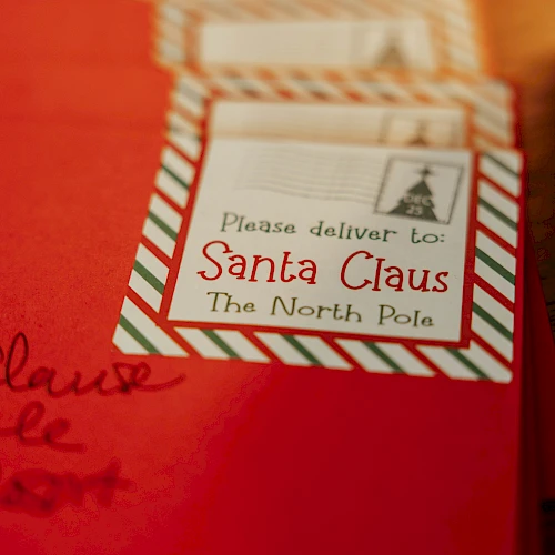 Red envelopes with a label saying, "Please deliver to Santa Claus, The North Pole," are shown in the image.
