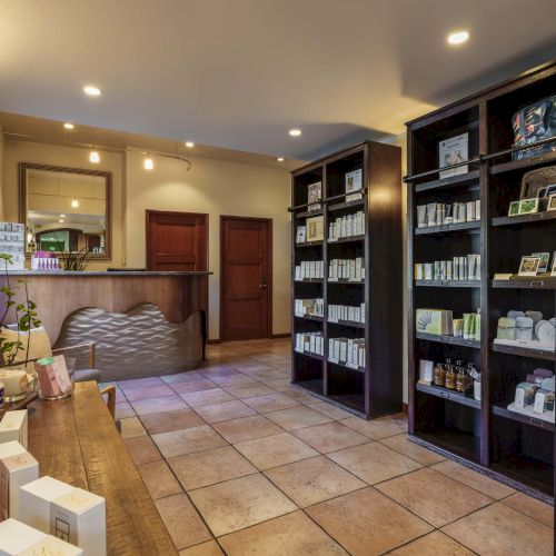A cozy home office and reading nook with built-in shelves, a wooden desk, warm lighting, and a small plant. Ends the sentence.
