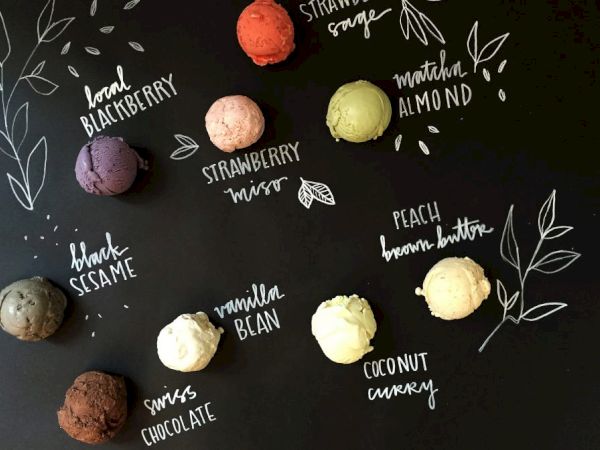 A blackboard-style menu displays various ice cream flavors: blackberry, strawberry, matcha almond, black sesame, vanilla bean, peach brown butter, coconut curry, and Swiss chocolate.