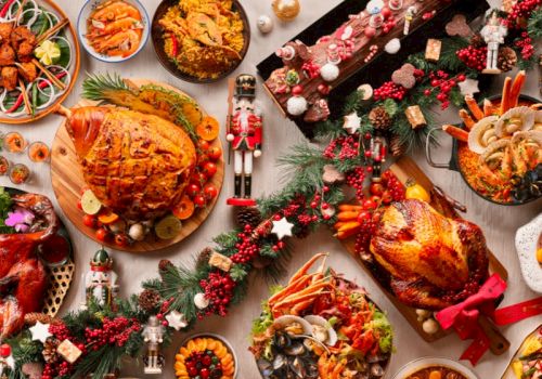 A festive spread featuring roasted meats, side dishes, desserts, garnished with holiday decorations and nutcracker figurines.