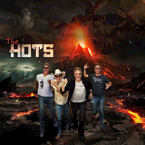 Four people stand in front of a volcanic eruption. The text "The Hots" appears on the left. The background features an erupting volcano and lava.