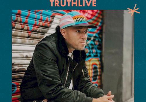 A man in a cap and jacket is sitting in front of a graffiti wall, promoting a "Vintage Spaces" event called "Truthlive" on August 17, 2024.