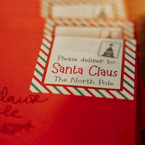 Red envelopes with a label saying, "Please deliver to Santa Claus, The North Pole," are shown in the image.